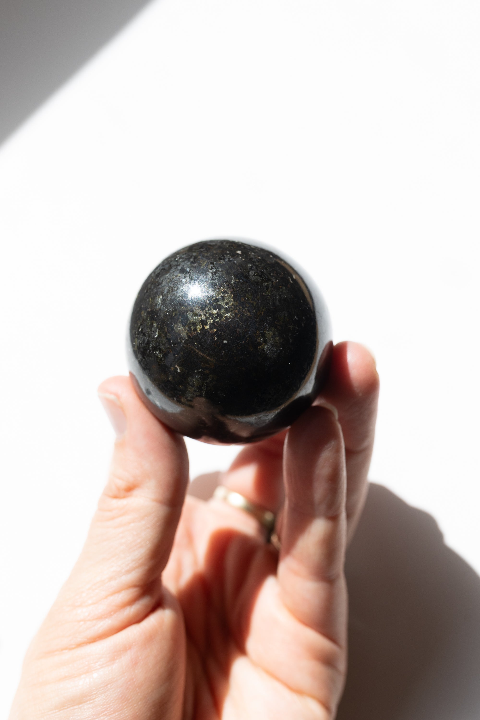 Nuummite Crystal Sphere #1 | Transformation • Psychic Protection • Ancient Wisdom