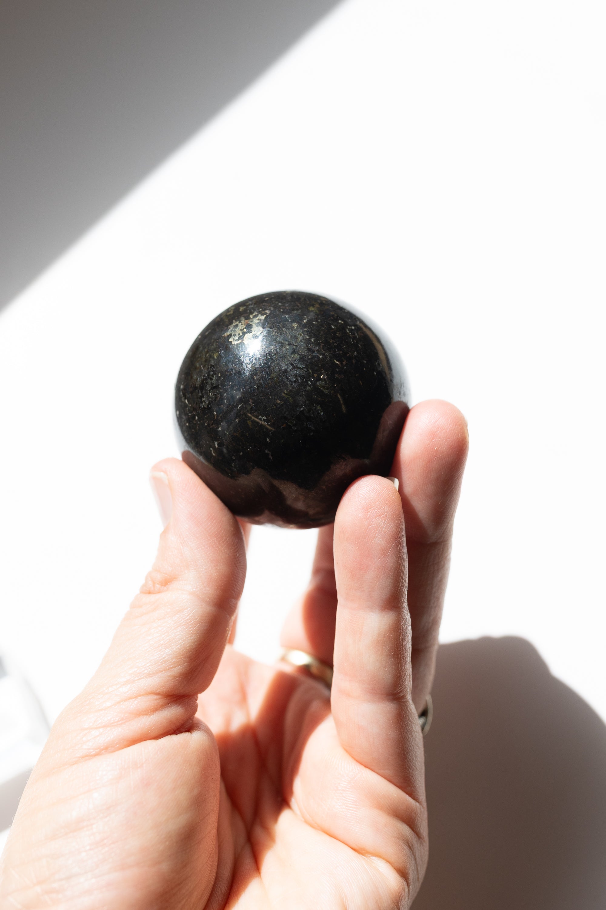 Nuummite Crystal Sphere #1 | Transformation • Psychic Protection • Ancient Wisdom