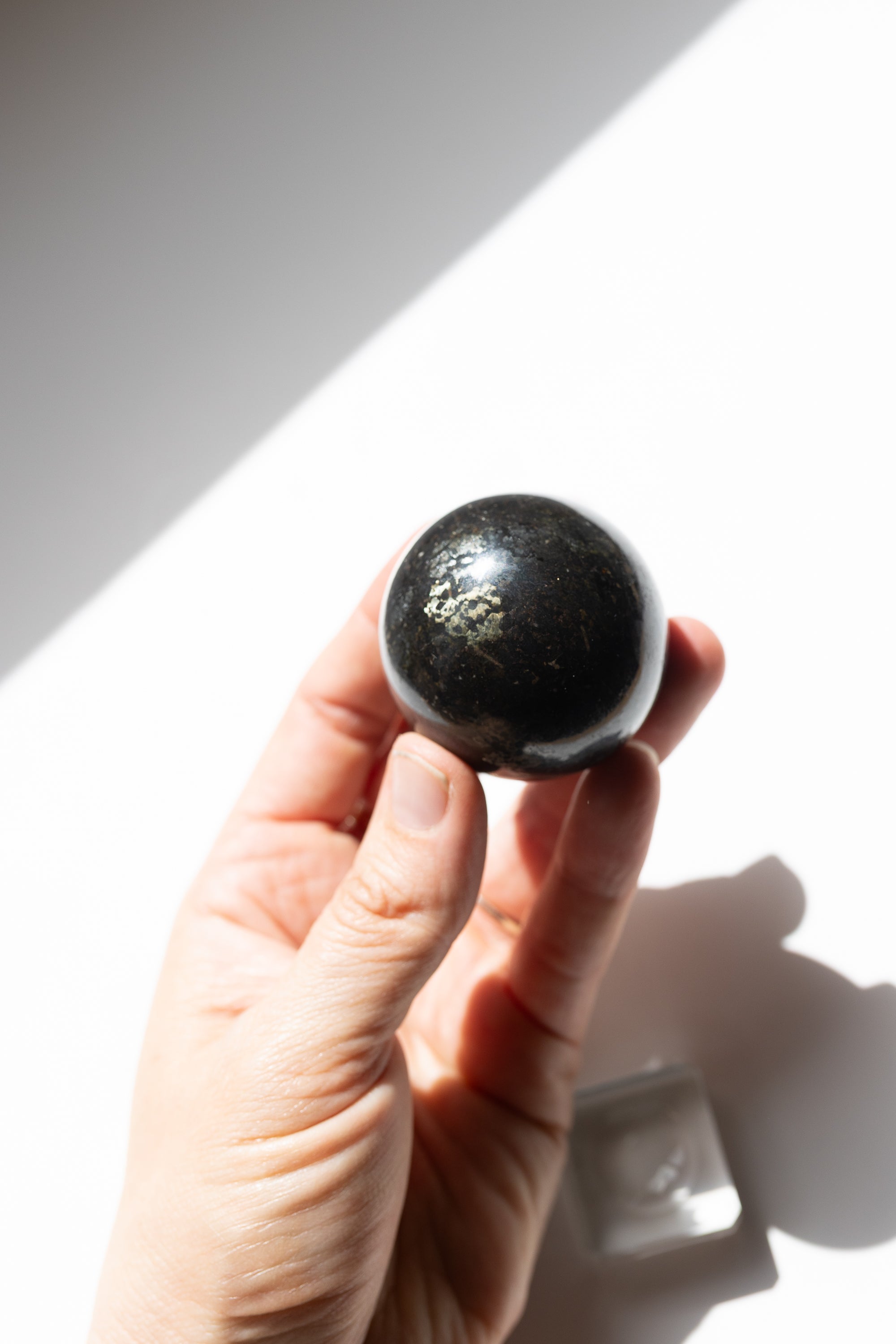 Nuummite Crystal Sphere #2 | Transformation • Psychic Protection • Ancient Wisdom